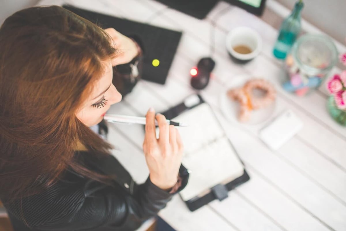 woman thinking about accounting practice problems, business pain points, and how to motivate employees.