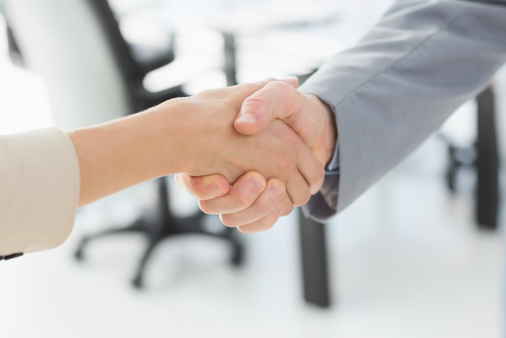 SME owner shaking hands after receiving financial transparency reports