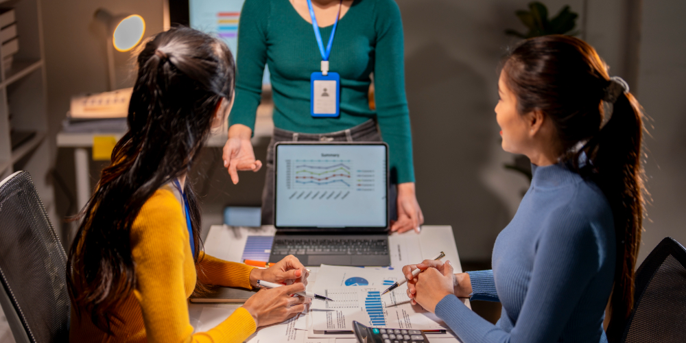 a team of accountants discussing how to build effective accounting workflows and SOPs
