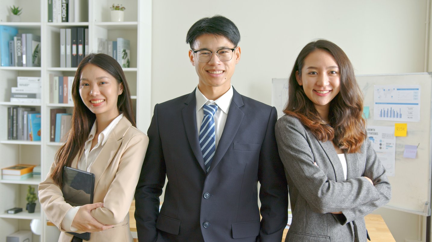 smiling-business-team-standing-together-in-the-off-2026-03-17-21-42-34-utc