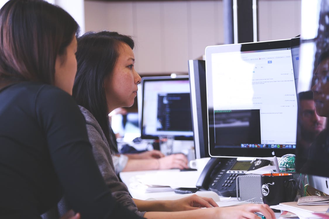employees discussing outsourced accounting challenges
