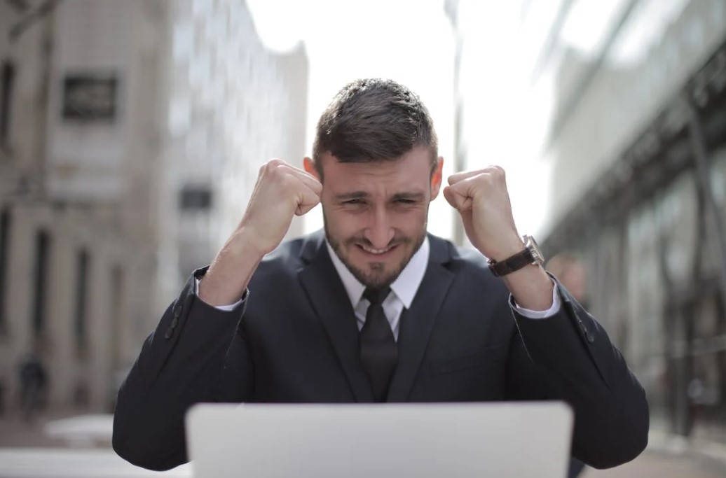 A business owner celebrating his company's success despite the rapidly evolving digital age