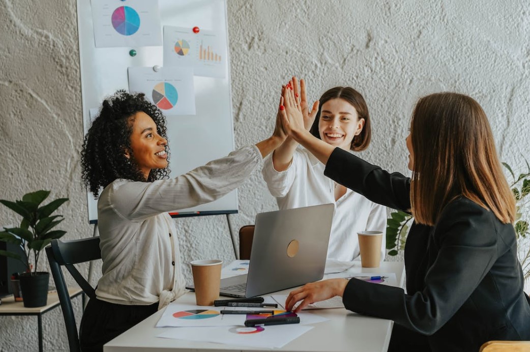Business owners happy at the success of their business after applying fund management strategies