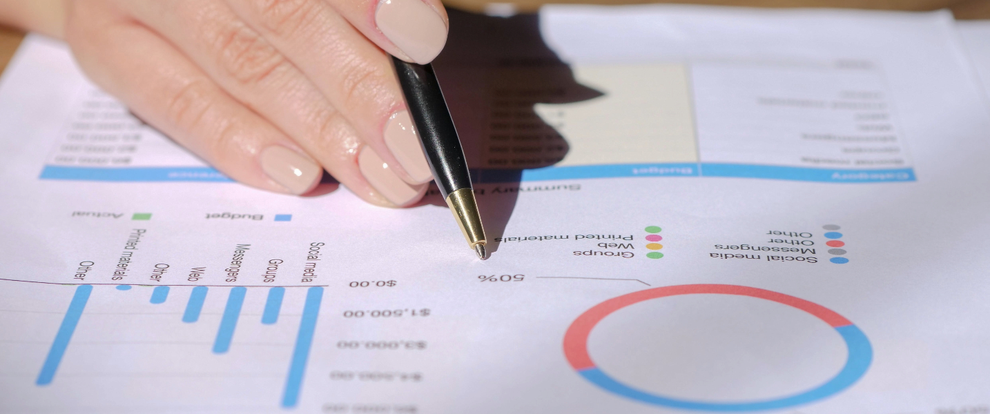 A person holding a black pen and writing on a white piece of paper, representing internal control, the process of ensuring that an organization's operations are efficient and effective, and that assets are protected.