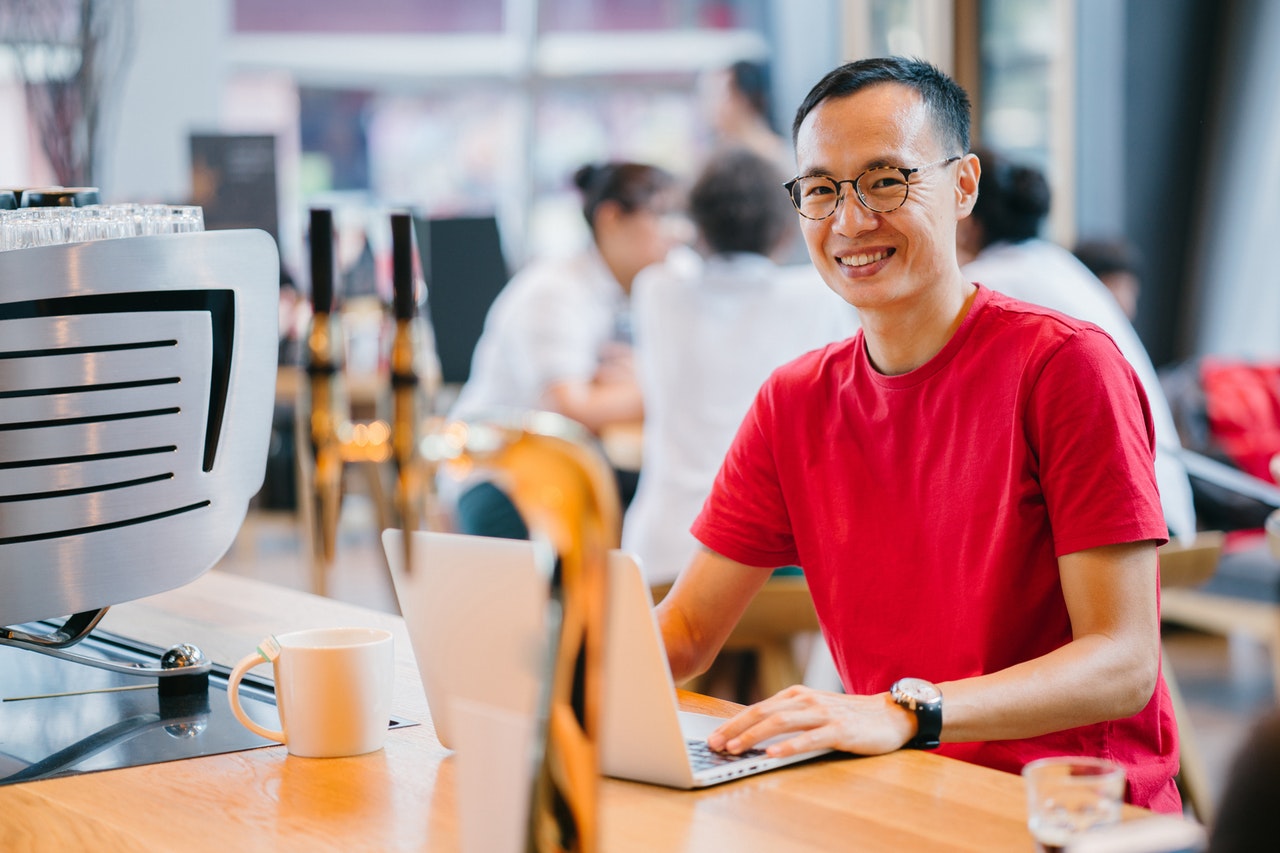 Man wearing red shirt investing his time with his personal and professional development