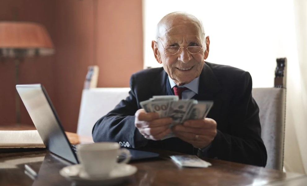 A business owner entrusting his money and about to hand it over to a reliable outsourced partner