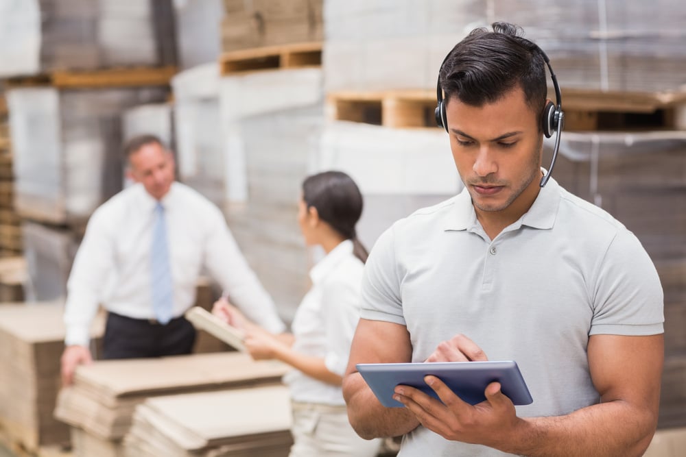 Female manager using digital tablet in warehouse