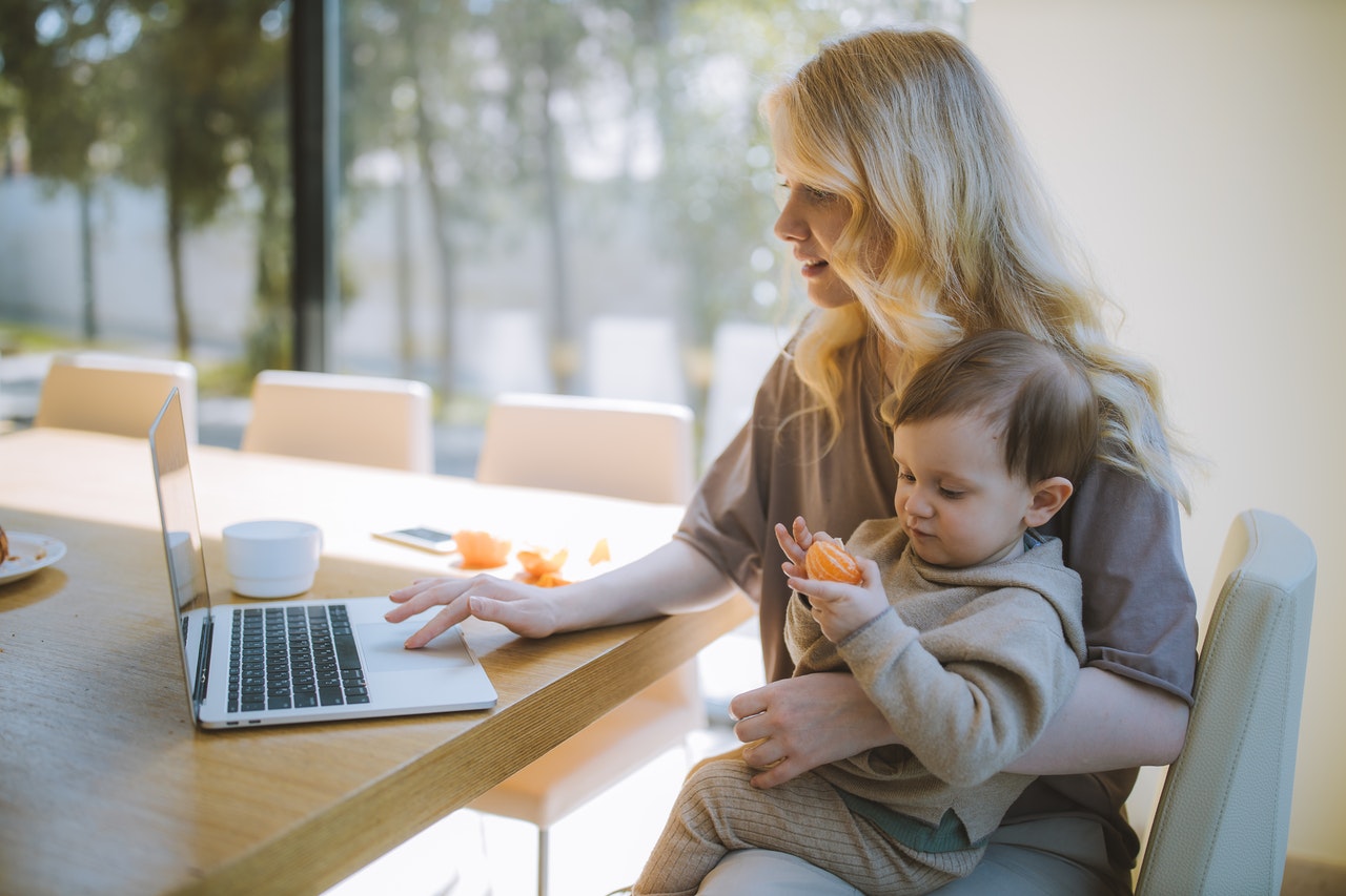 Woman working from home with child