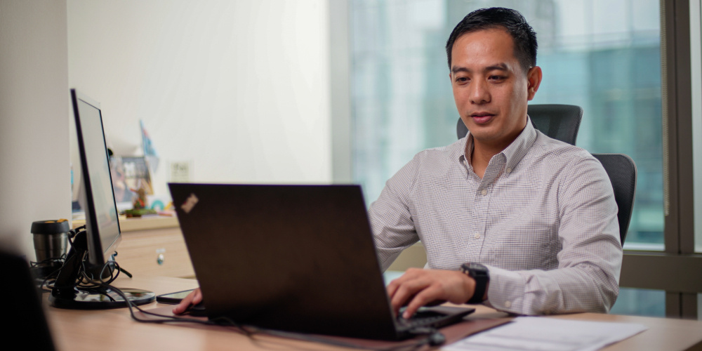 A man is reading a blog about why consider accounting outsourcing for your canadian company