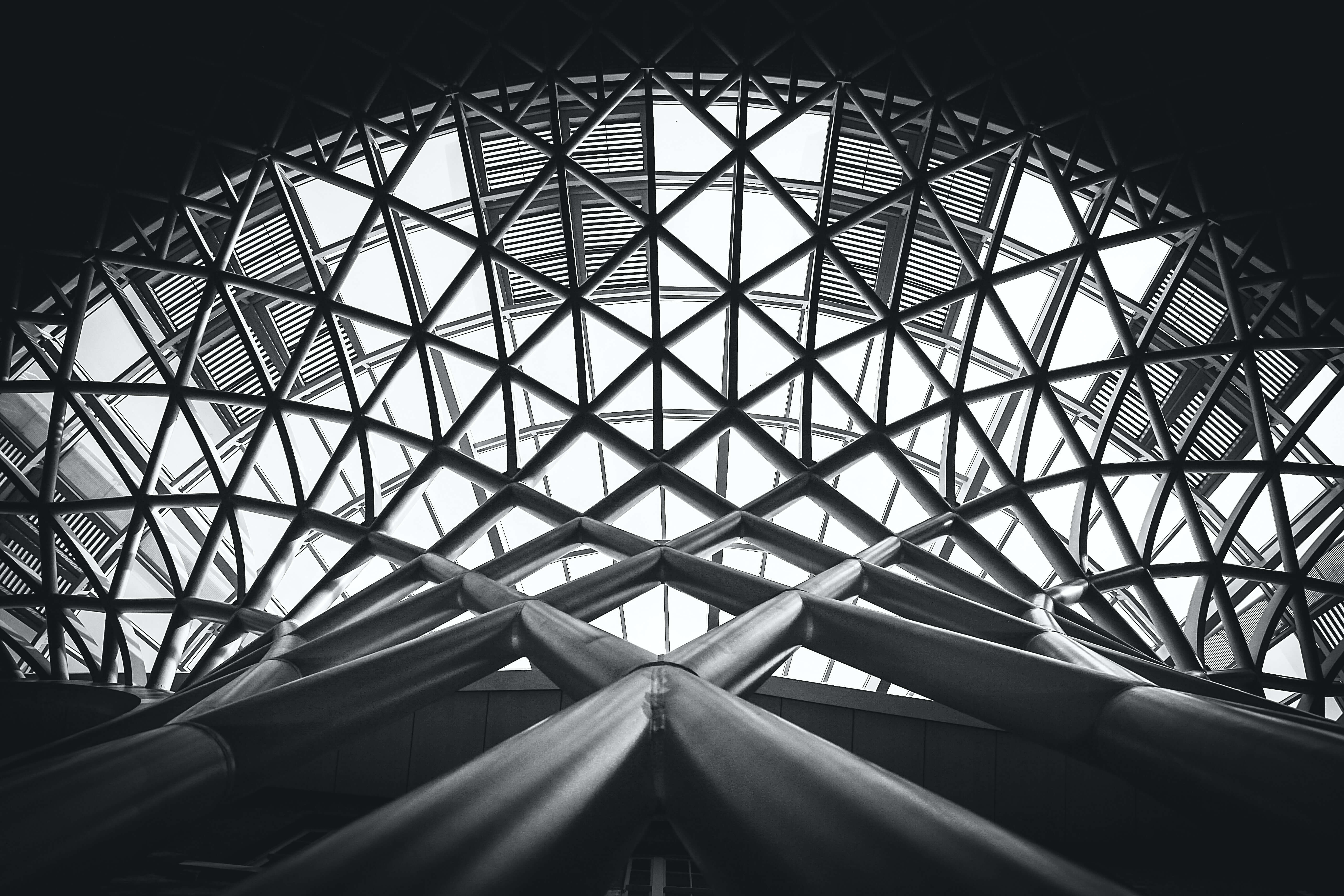 low-angle-photography-of-metal-building-on-grayscale  