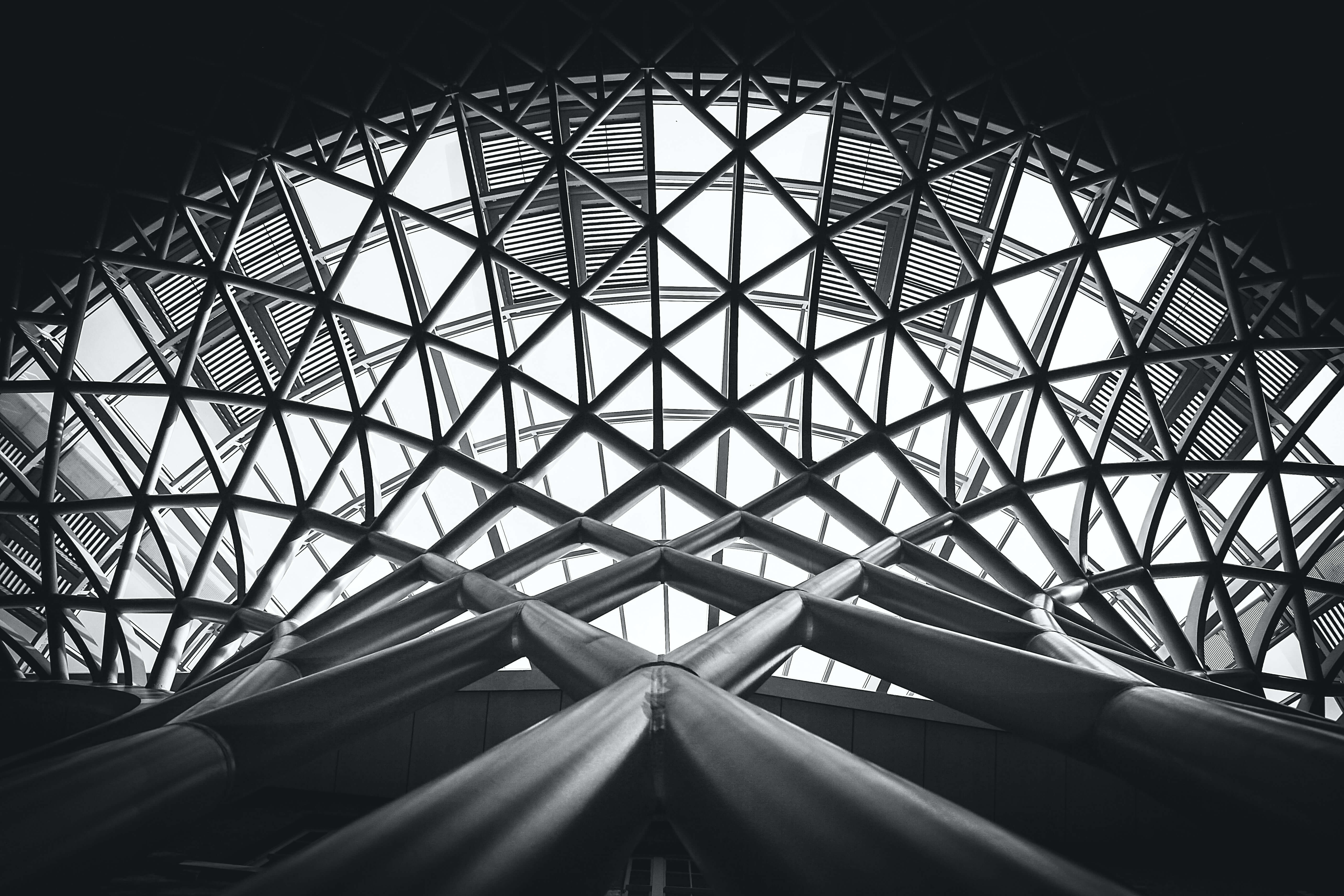 low-angle-photography-of-metal-building-on-grayscale