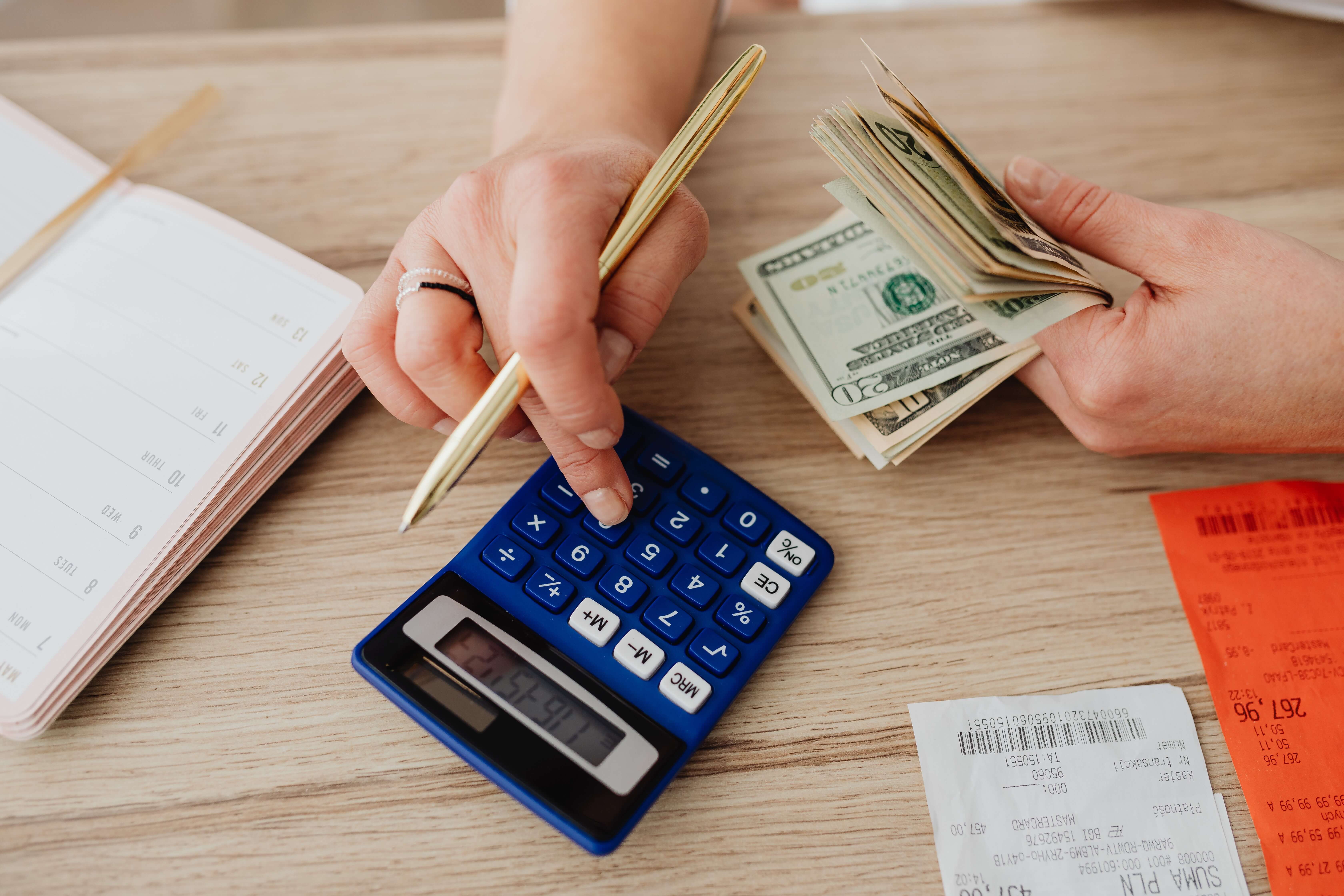 women-calculating-money-and-receipts-using-a-calculator