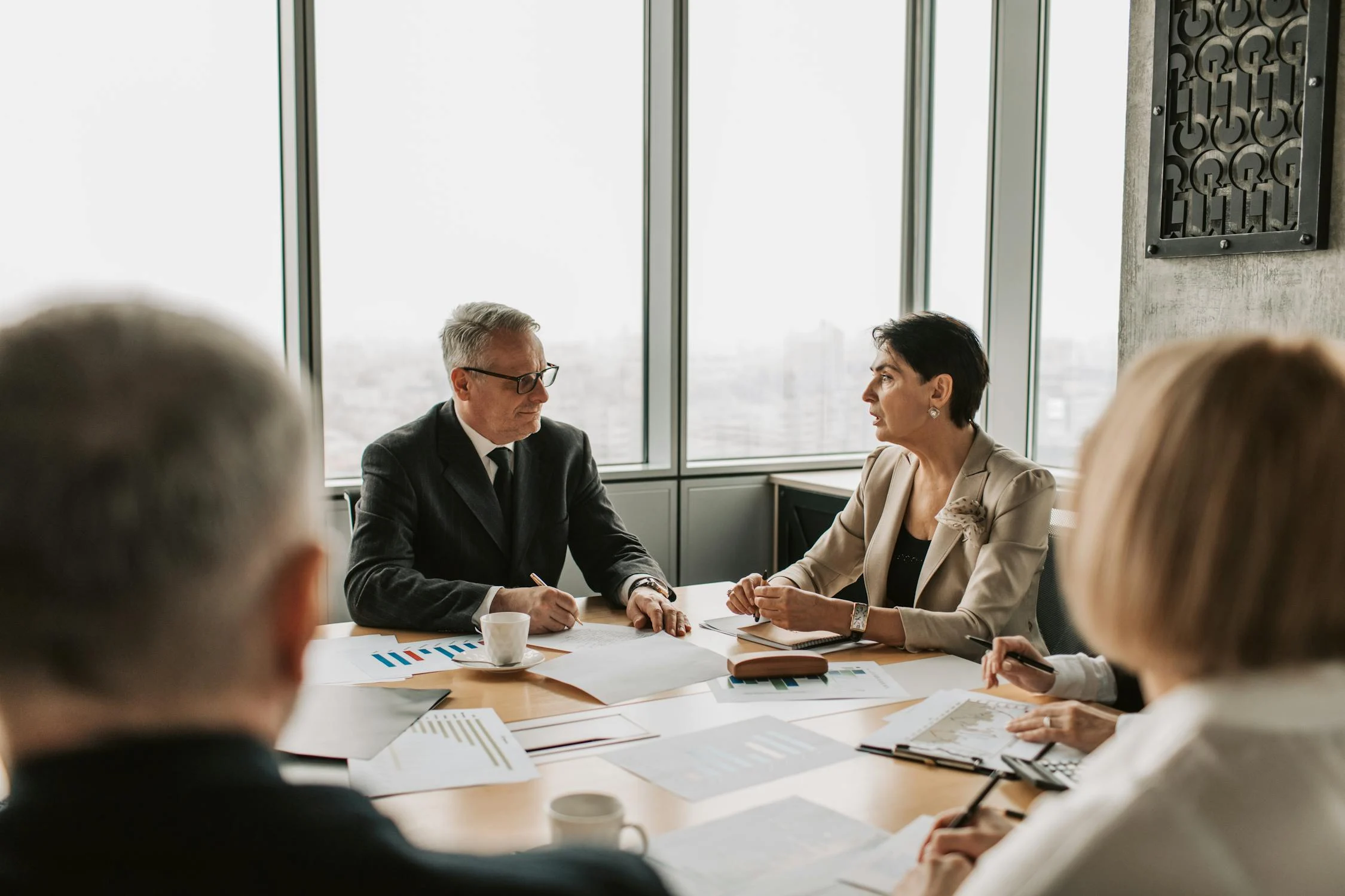 Advisers discussing financial wealth management strategies with their company